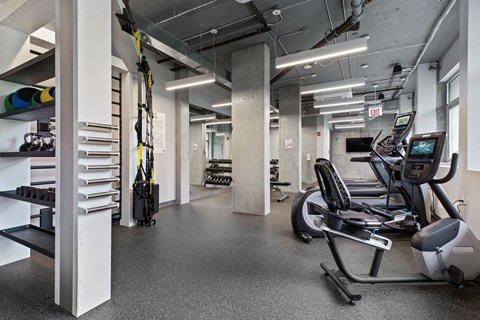 A gym with treadmills, exercise bikes, and other equipment.