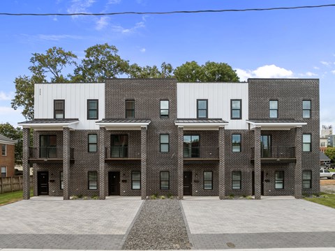 A modern building with a combination of brick and white panels.
