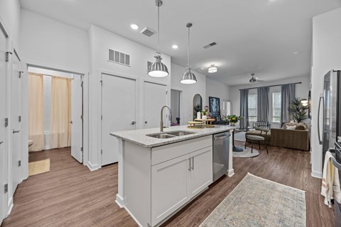 A modern kitchen with a large island and pendant lights.at Address East End, North Carolina