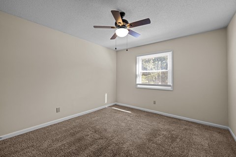 an empty room with a ceiling fan and a window at Raleigh Rentals, Raleigh, NC