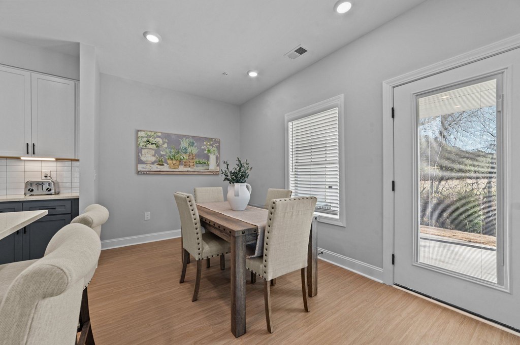 A dining room with a table set for four.