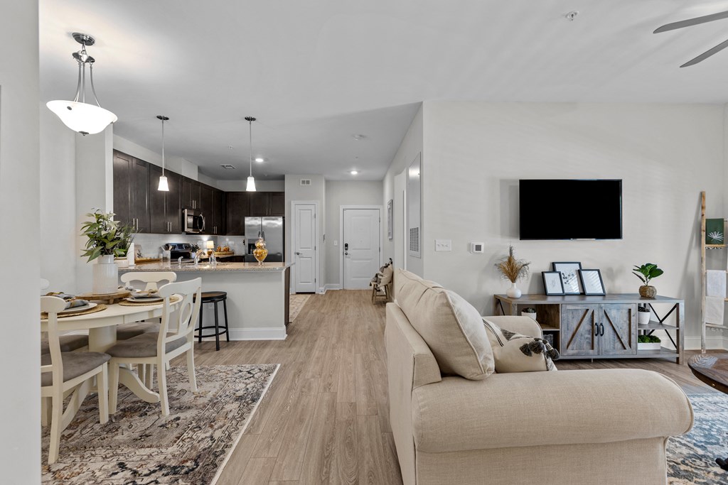 a living room with a couch and a dining table