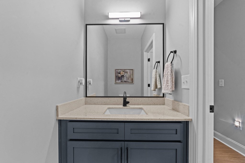 A bathroom with a sink and a mirror.at Regency Townes, Winterville, 28590