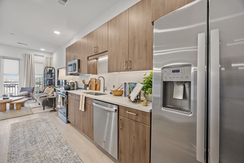 A modern kitchen with a refrigerator on the right side.