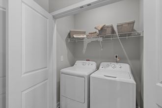 a white washer and dryer in a laundry room with two white washes