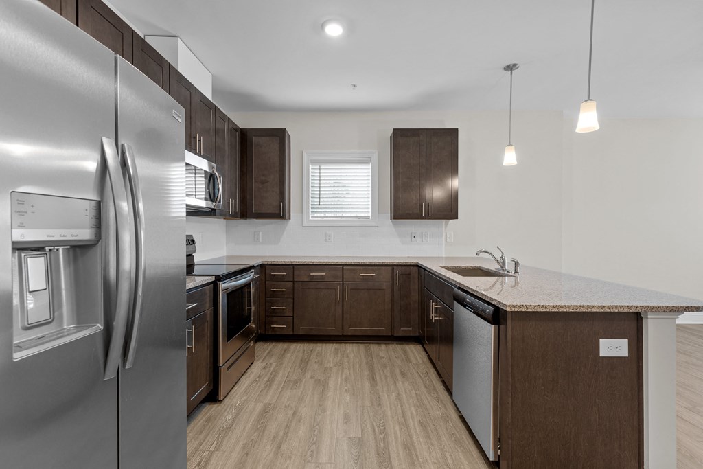 a kitchen with stainless steel appliances and wooden cabinets