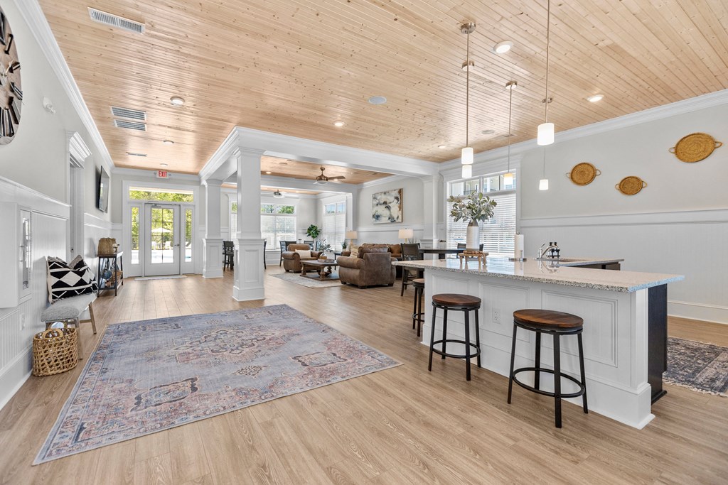 a large living room with a kitchen and a bar