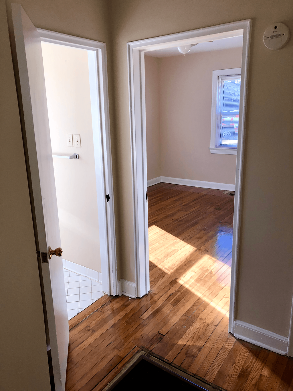 a room with a hard wood floor and an open door