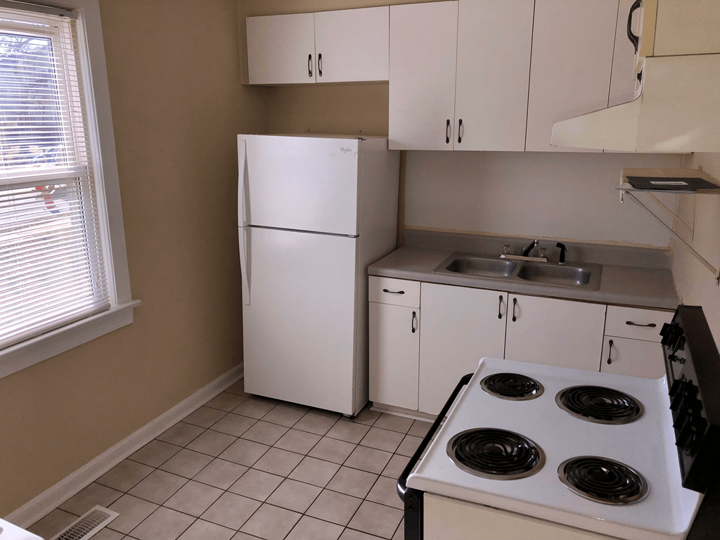 a kitchen with a stove and a refrigerator