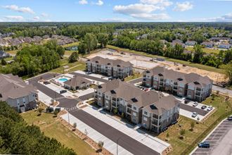 an aerial view of several apartment buildings and a parking lot