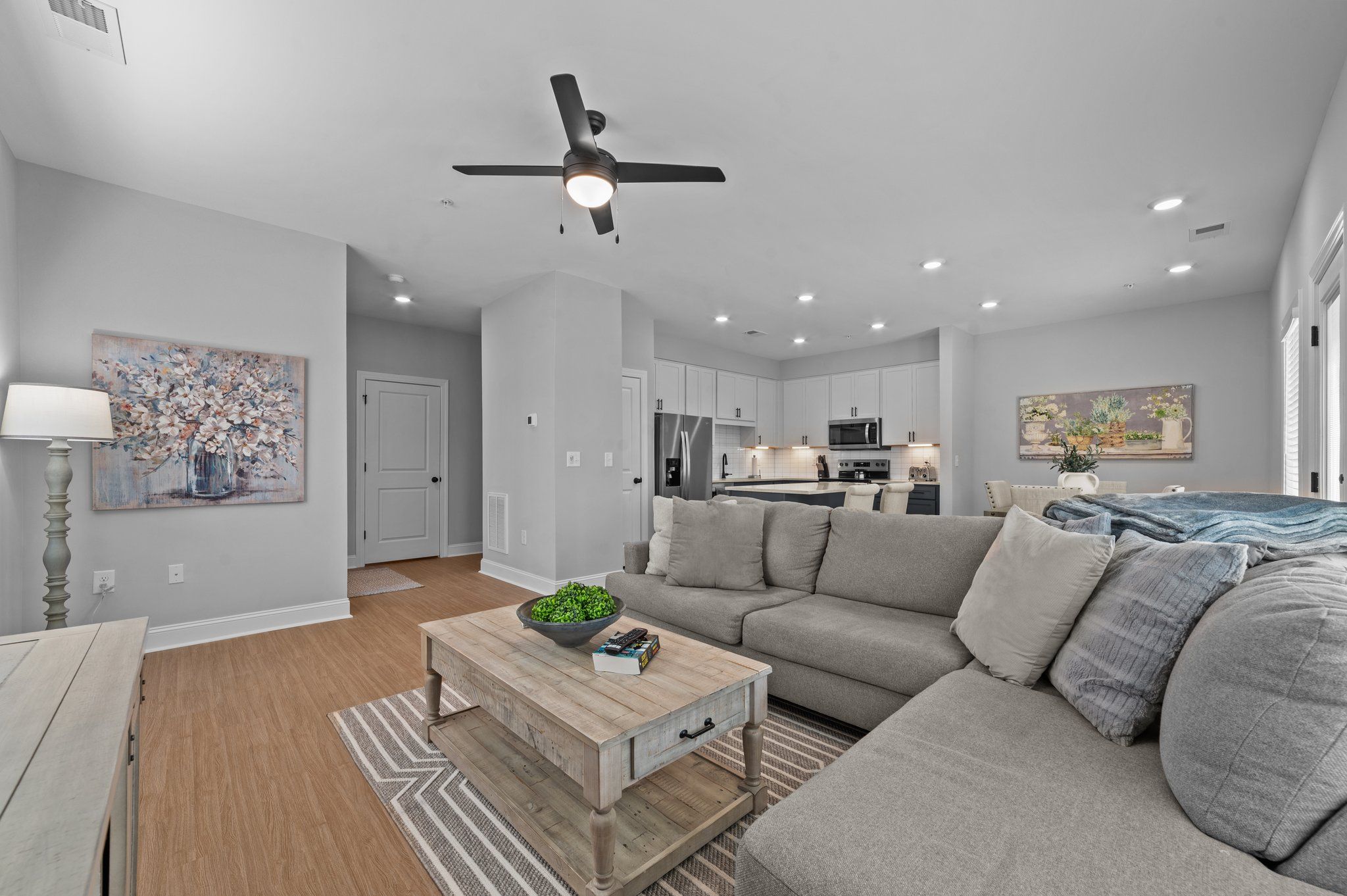 A modern living room with a grey sofa and a coffee table.