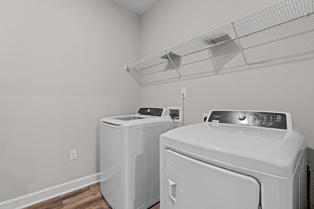 the laundry room has two washes and a dryer in it with a rack