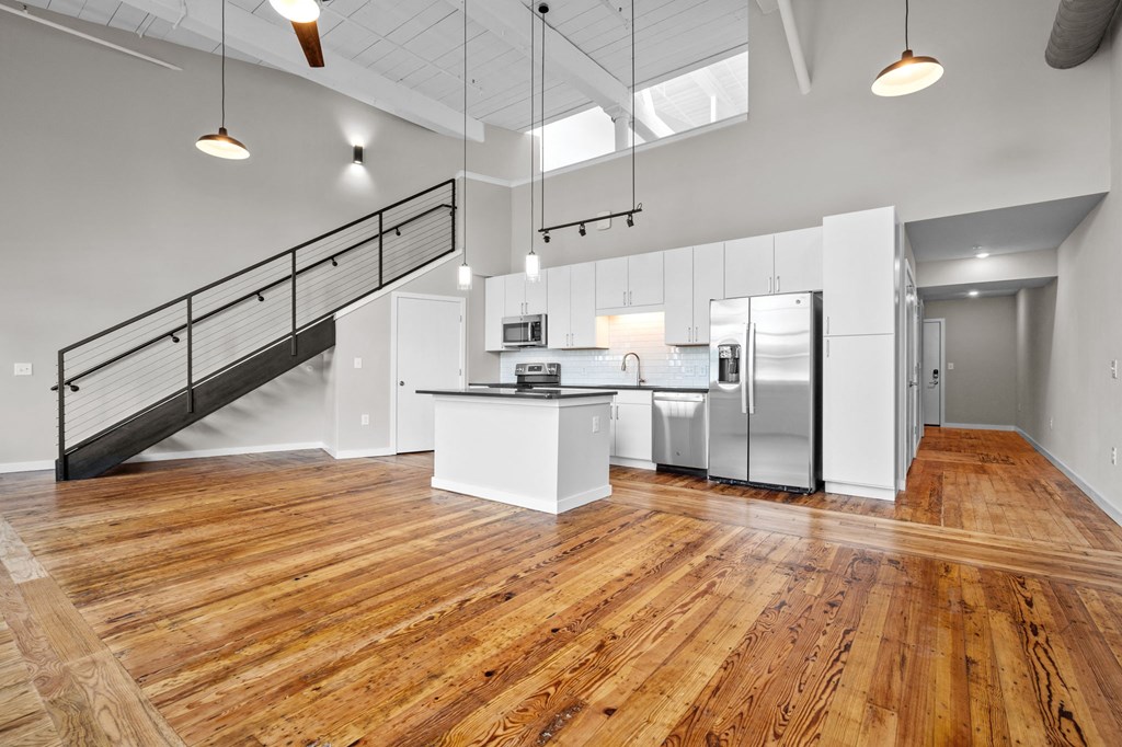 an open kitchen with stainless steel appliances and white cabinets