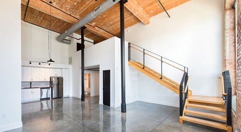 A room with a wooden ceiling and a staircase.
