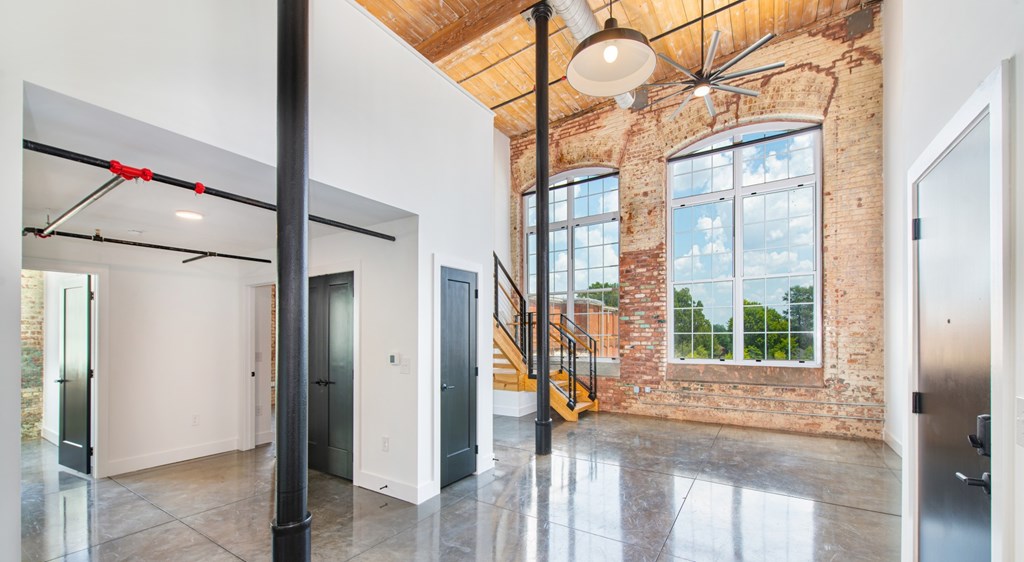 A large open space with a brick wall and a staircase.