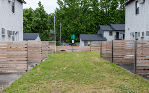 A white house with a wooden fence in front of it.