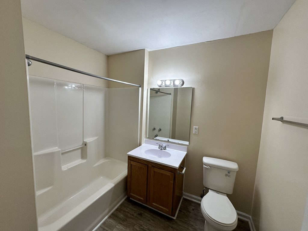an empty bathroom with a toilet sink and shower