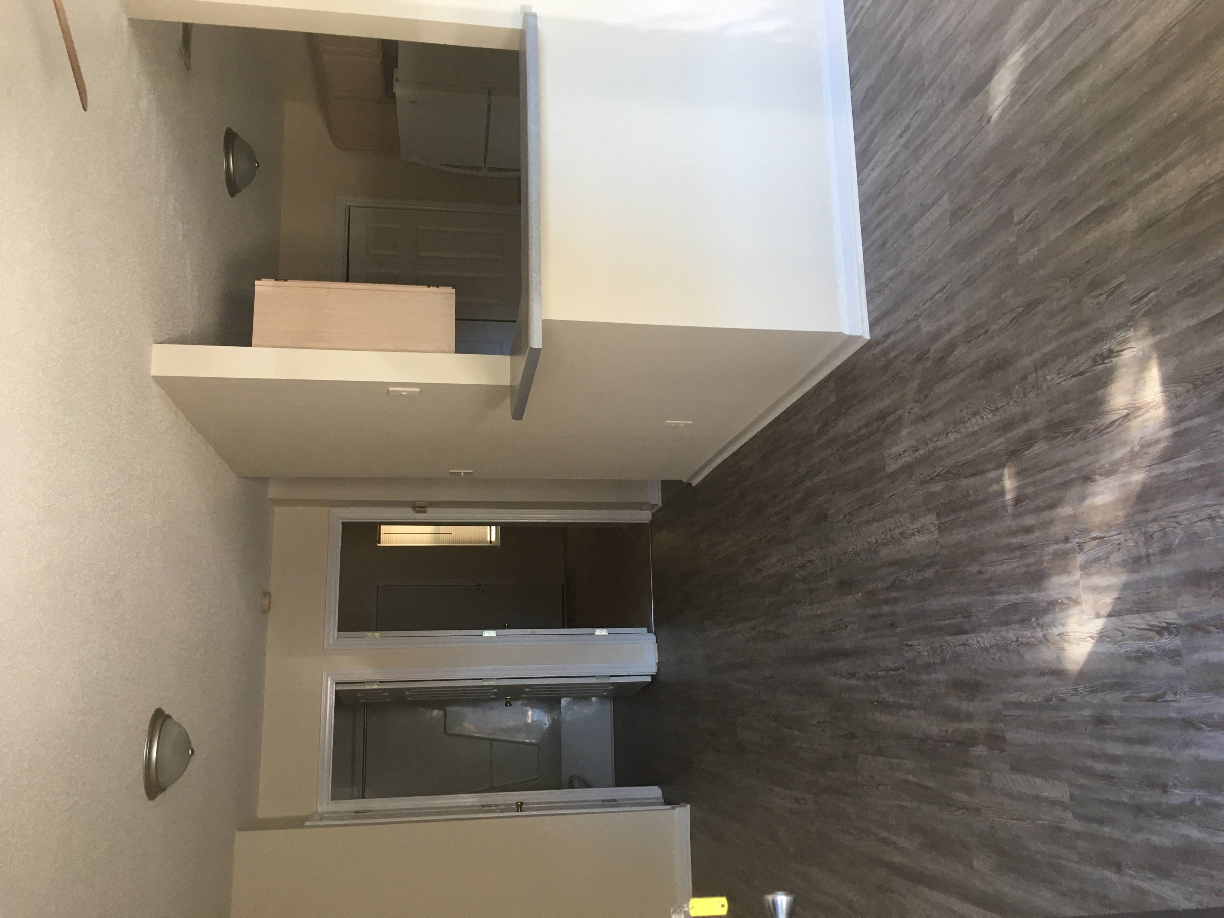 an overhead view of a kitchen with a refrigerator and a microwave