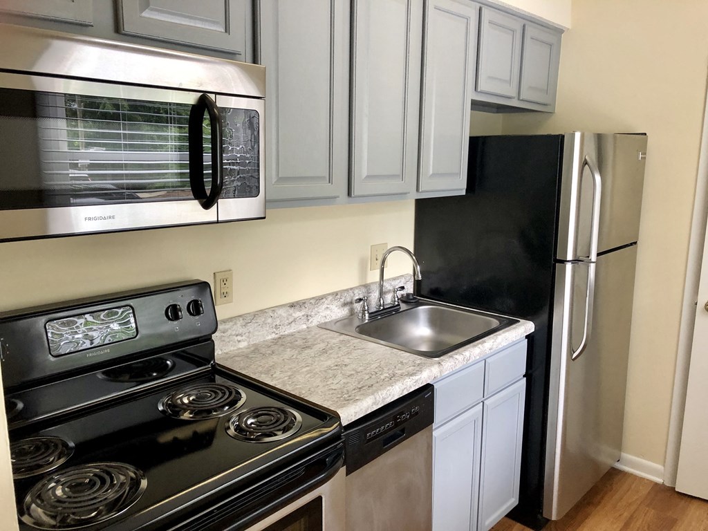 a kitchen with stainless steel appliances and white cabinets