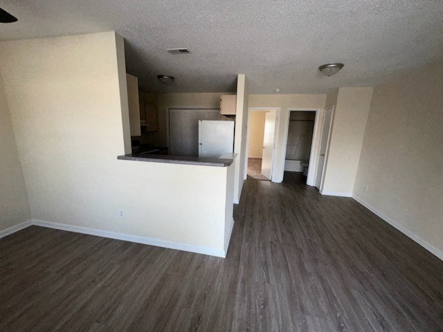 an empty living room and kitchen in an empty house