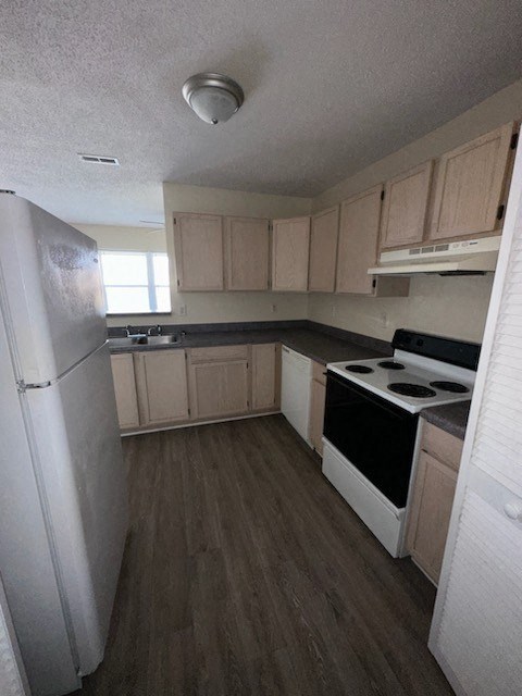 an empty kitchen with wood floors and white cabinets