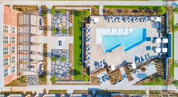 An aerial view of a building with a swimming pool and a courtyard with a fountain at Judson Mill Lofts, Greenville, South Carolina