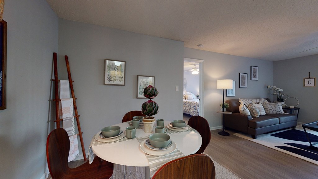 an open living room and dining room with a white table and chairs