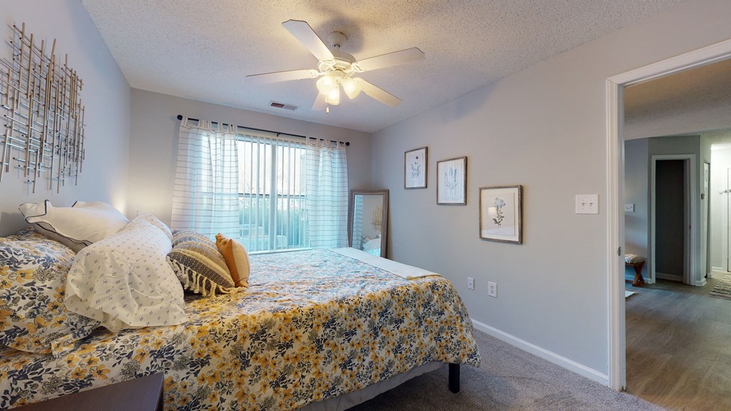 a bedroom with a bed and a ceiling fan