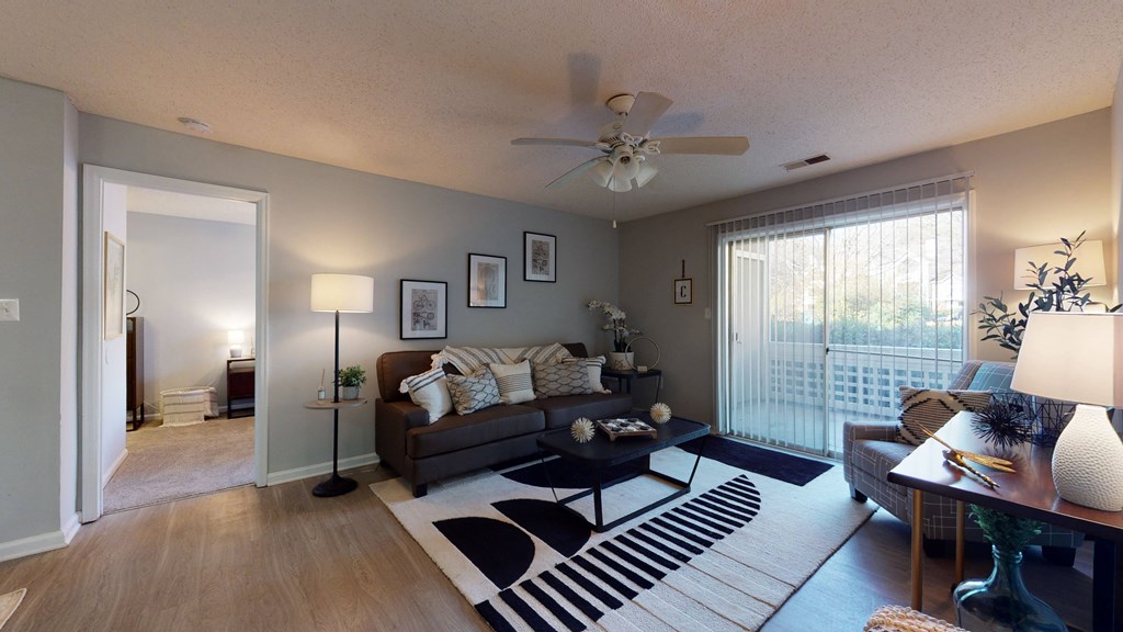 a living room with a couch and a ceiling fan