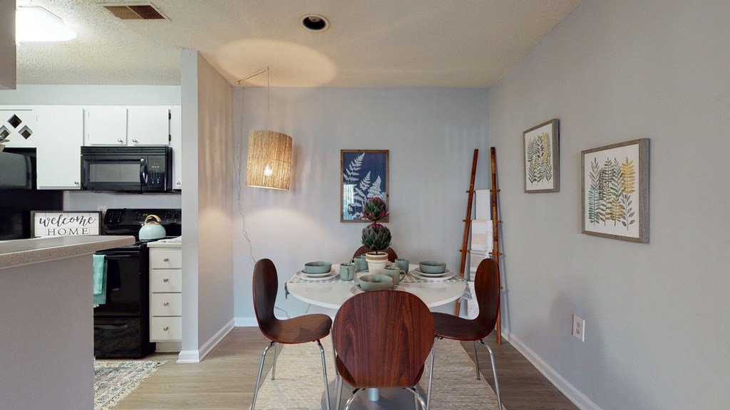 a dining room with a table and chairs and a kitchen