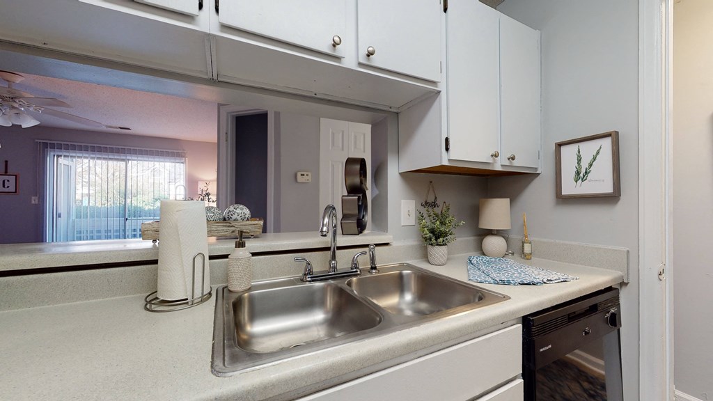 a kitchen with a sink and a mirror