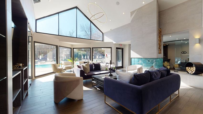 a living room with couches and chairs and a pool