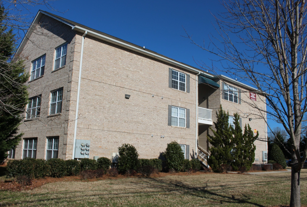 the exterior of a brick apartment building