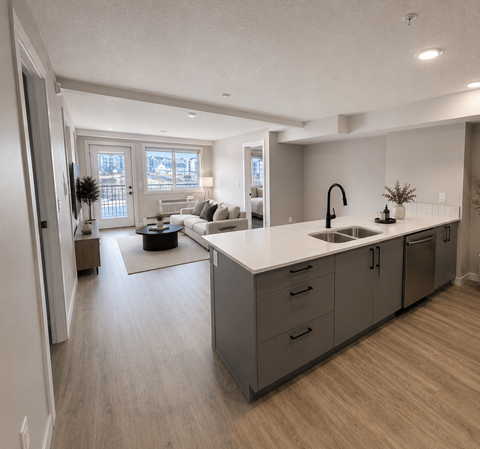 A modern kitchen with a large island and stainless steel appliances.