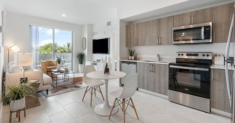 a living room with a kitchen and a table