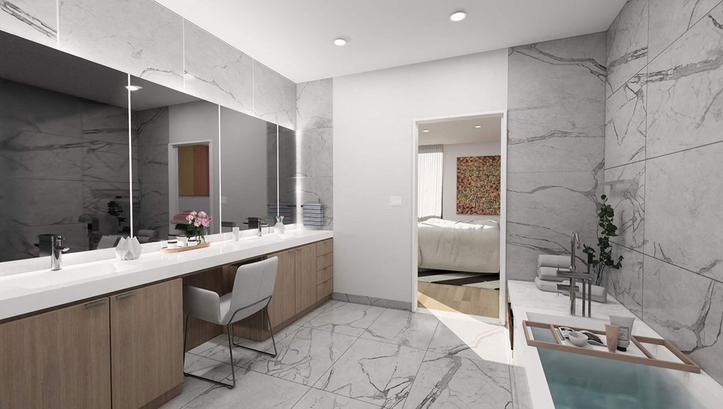 a bathroom with a sink and a mirror and a bed