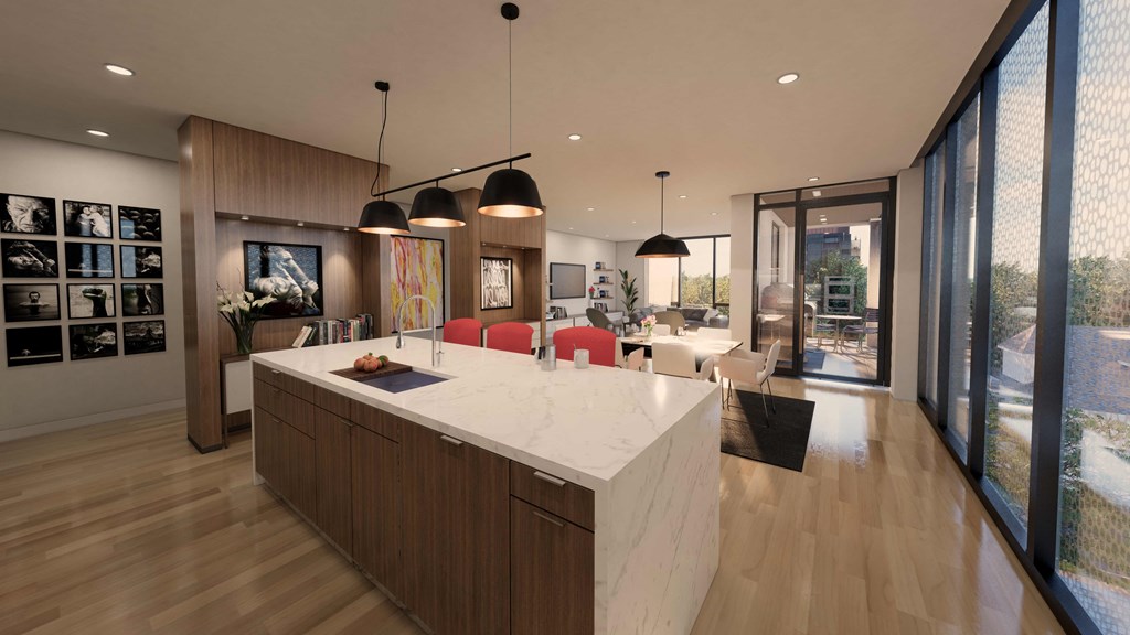 a large kitchen and living room with a marble counter top