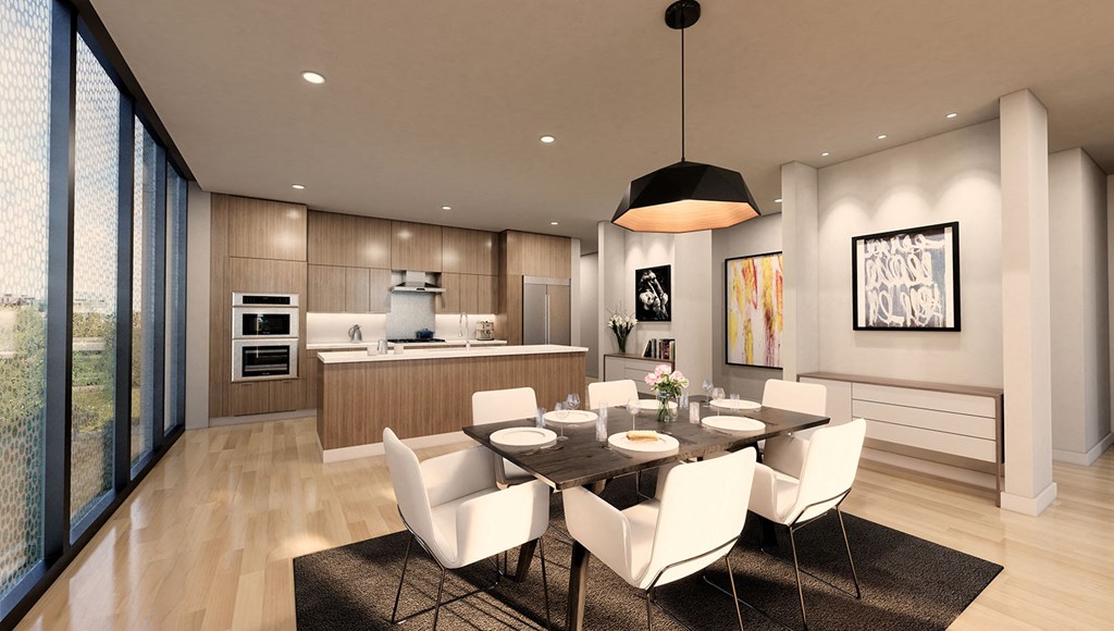 a dining room and kitchen with a table and chairs