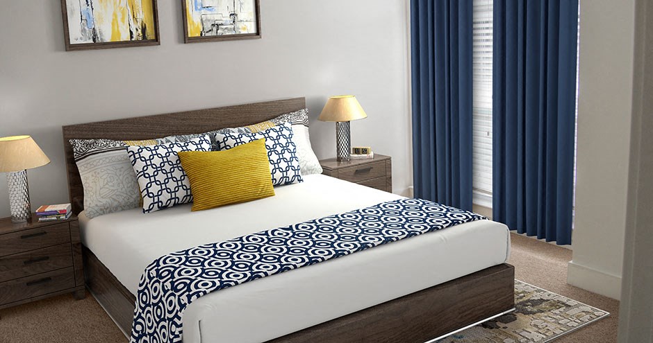 a bedroom with a white bed and blue curtains