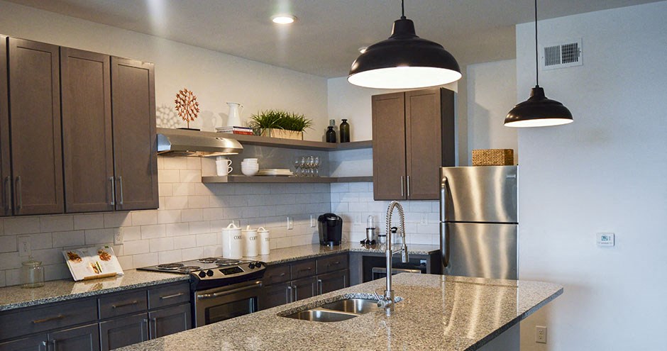 a kitchen with a counter top and a refrigerator