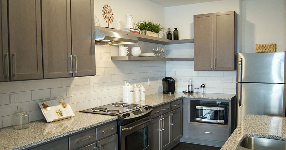 a kitchen with stainless steel appliances and granite counter tops