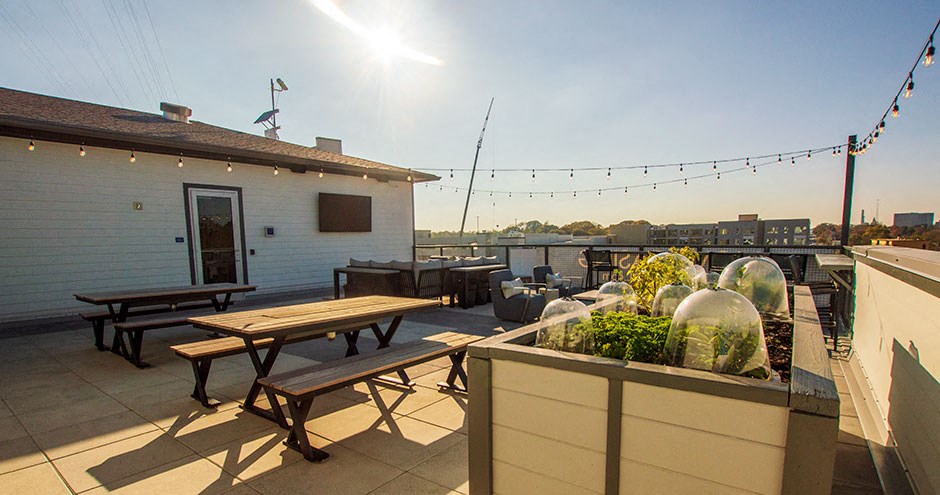 a patio with picnic tables on a roof