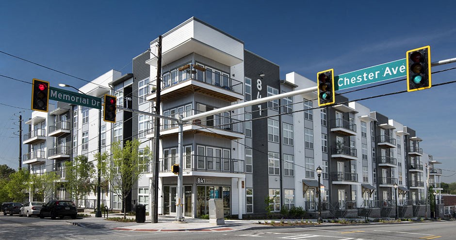 a large building on the corner of an intersection with traffic lights