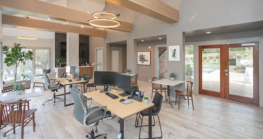 a conference room with tables and chairs and sliding glass doors