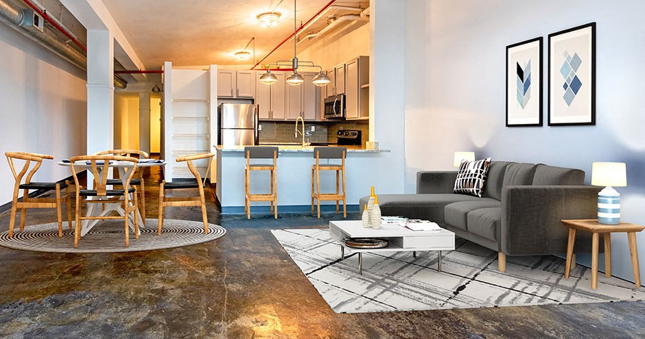 a living room and kitchen with a couch and a table