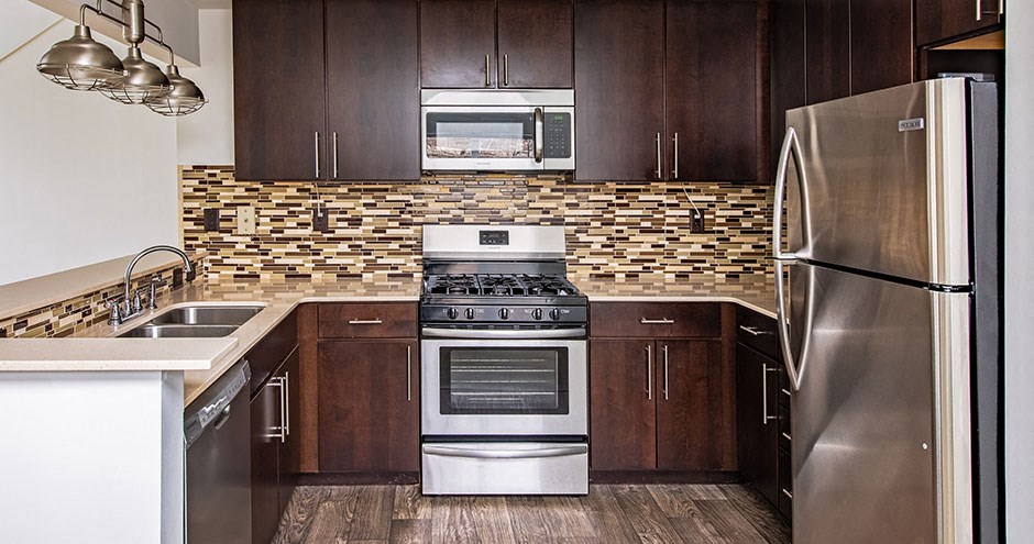 a kitchen with stainless steel appliances and wooden cabinets