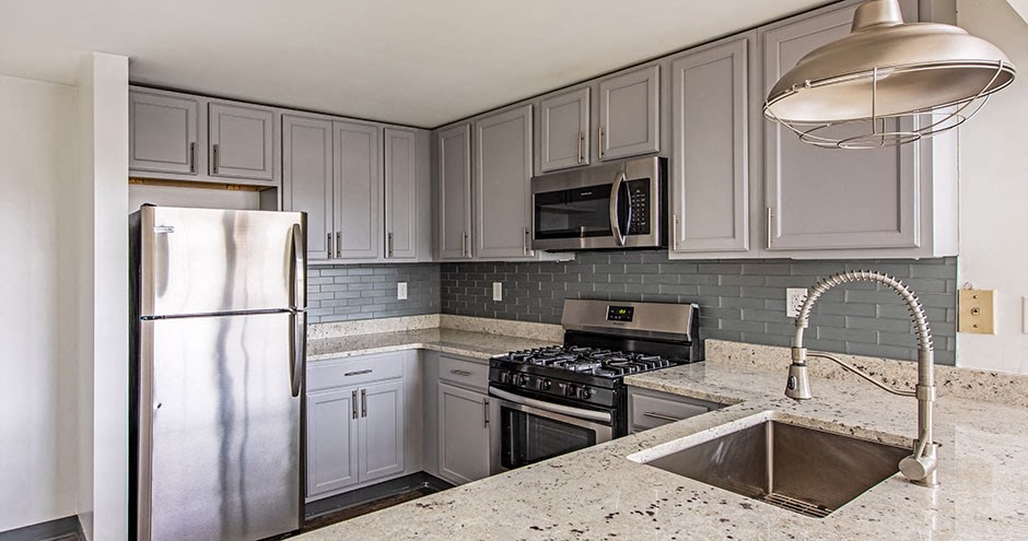 a kitchen with stainless steel appliances and white cabinets