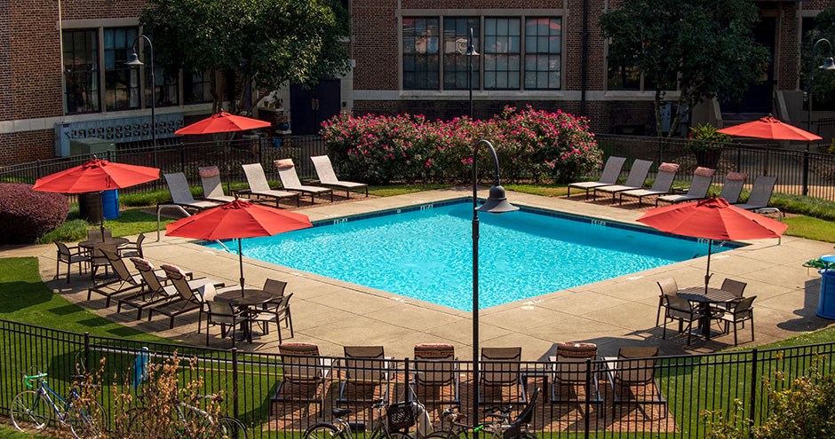 a swimming pool with umbrellas and chairs around it