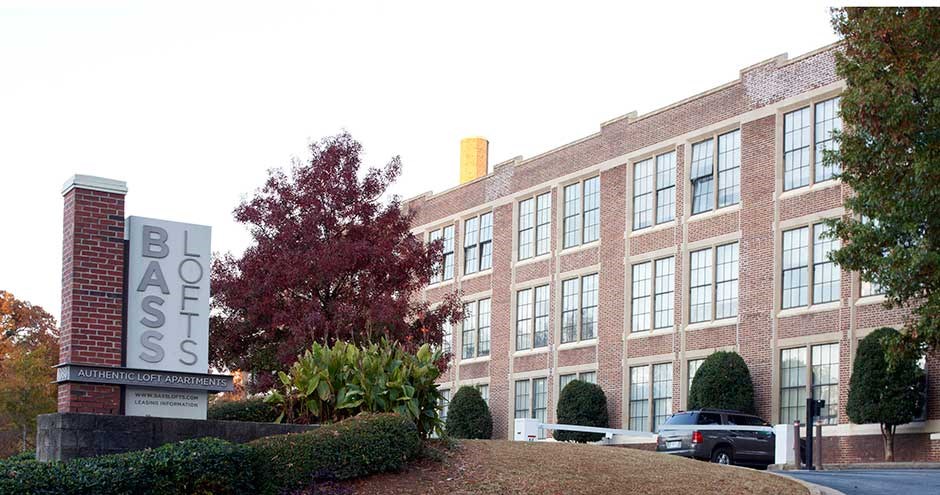 a large brick building with a sign in front of it