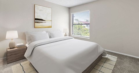 A bedroom with a large bed and a painting on the wall.
